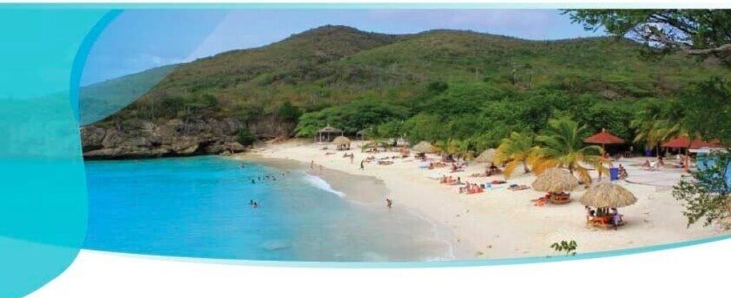 Experience the Full day Westpunt Tour: relax on white sand beaches with clear blue water and palm trees, unwind under palapa umbrellas, swim along the shore, and admire green hills in the background—all on a tropical getaway.