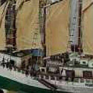 The Curaçao Maritime Museum features an indoor display of a tall ship model with cream sails, multiple masts, and intricate rigging behind white railings, highlighting historical maritime craftsmanship.