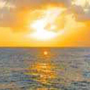 Sunset Spanish Water captures a vibrant sunset with golden light reflecting on the ocean, partly cloudy skies, and rocky silhouettes along the shore, creating a calm and serene atmosphere.